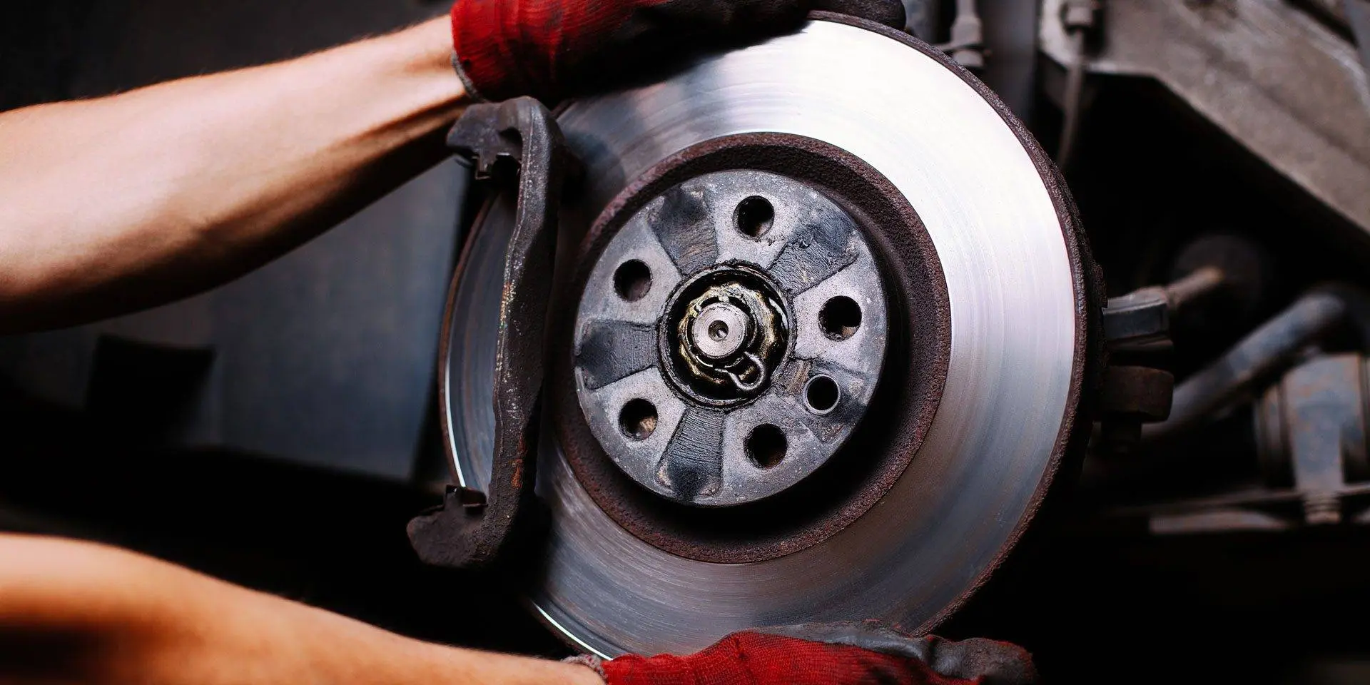 A brake rotor and pads being changed