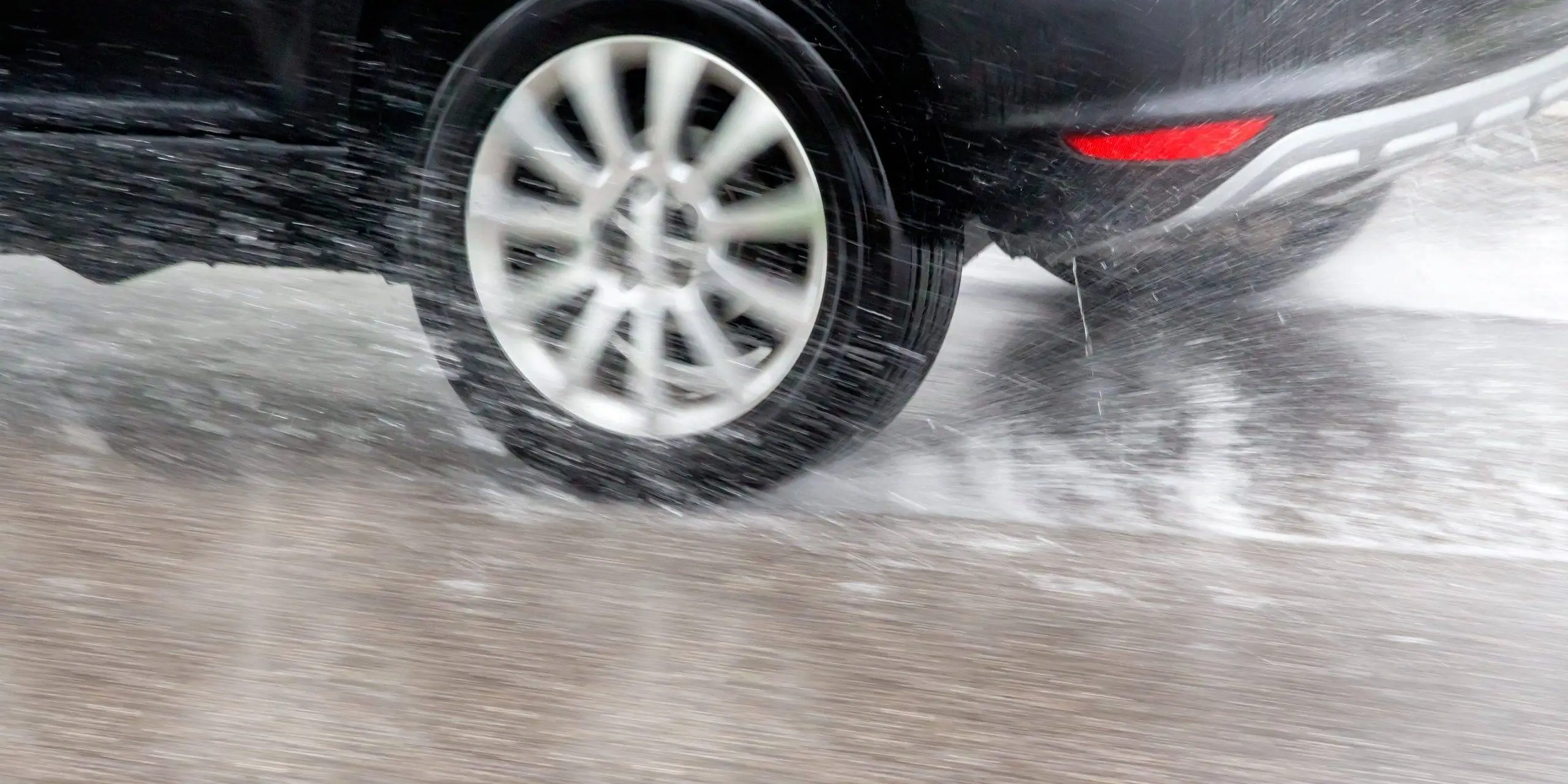 A vehicle running on a wet road